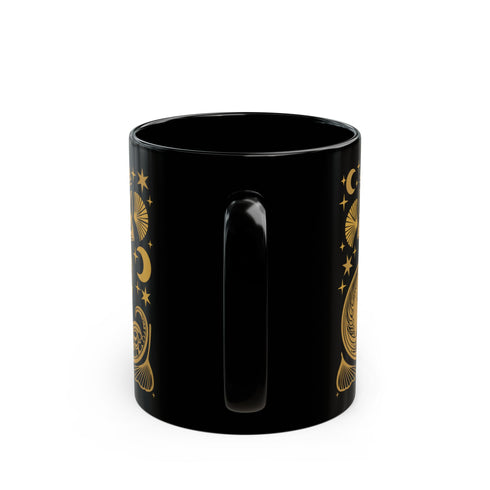 A black ceramic mug featuring a stylized golden fox design surrounded by Art Deco ginkgo fans, crescent moons, and stars. The mug has a glossy finish and ergonomic handle.